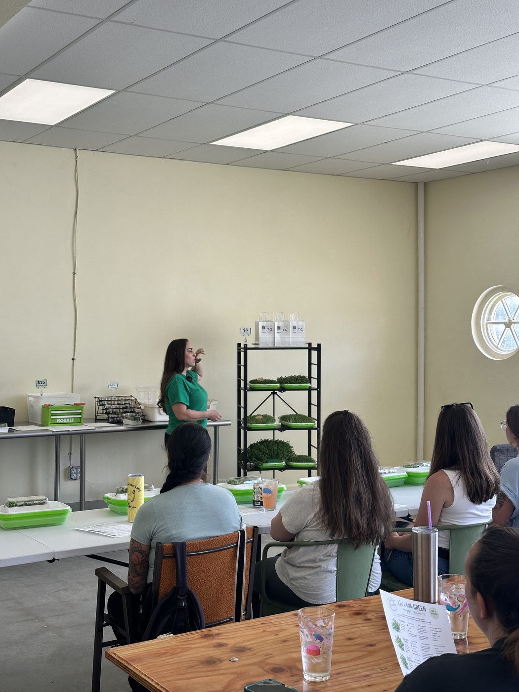 A full room of attendees at a previous Teeny Greeny microgreens class, each with trays and handouts on the tables
